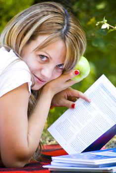 beautiful young woman working out with laptop and reading books