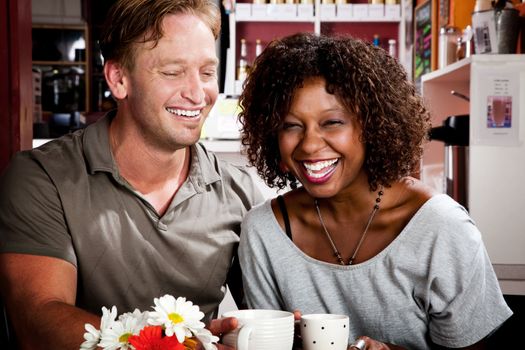 Caucasian man and African American woman in coffee house