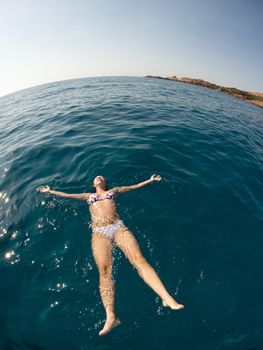 Pretty woman enjoying her swimming in the ocean