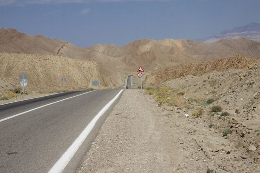 Straight mountain route in Iran. Summer day - Desert
