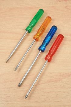 four screwdrivers on wood