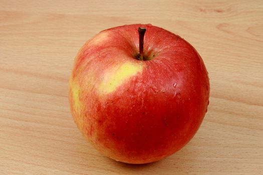 red apple on wooden desk