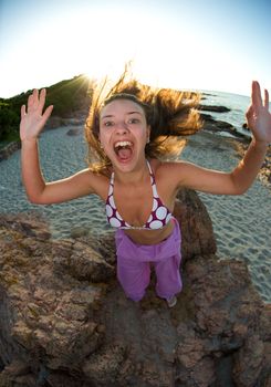 Crazy pretty woman enjoying the beach at sunset time