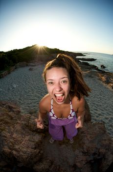 Crazy pretty woman enjoying the beach at sunset time