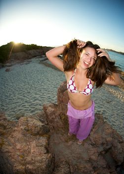 Crazy pretty woman enjoying the beach at sunset time