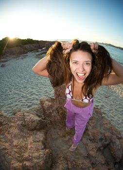 Crazy pretty woman enjoying the beach at sunset time