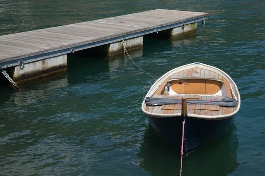 Wooden jetty and boat on Lake Como (Italy)