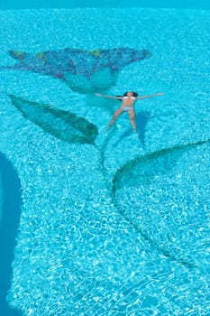 Woman relaxing in the spa swimming pool