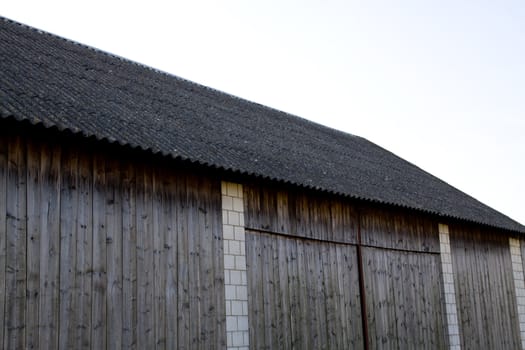 detail of vintage barn made of wood and white stone