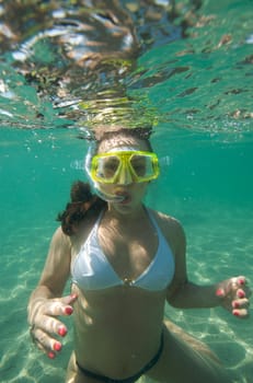 Woman doing snorkeling with goggles and scuba