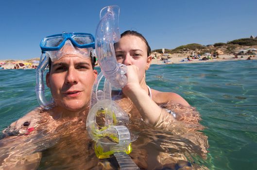 Lovely couple enjoying snorkeling during their vacation