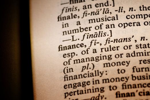 Closeup of the word finance with a spot light on the text