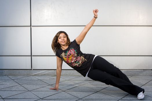 Young teenager grooving to hip hop music on the dance floor