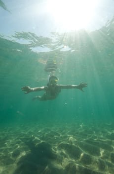 Woman doing snorkeling with goggles and scuba