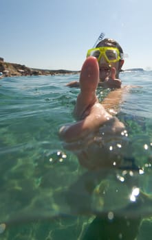 Woman doing snorkeling with goggles and scuba