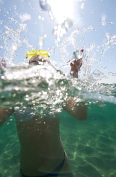 Woman doing snorkeling with goggles and scuba