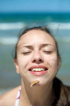 Woman playing with some shells on the beach