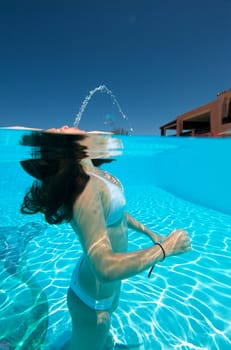 Underwater view of a woman swimming in the swimming pool