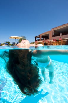 Underwater view of a woman swimming in the swimming pool