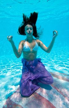 Underwater view of a woman swimming in the swimming pool