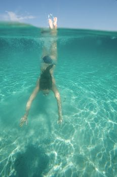 Underwater view of a woman swimming in the ocean