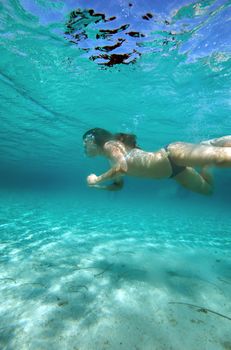 Underwater view of a woman swimming in the ocean