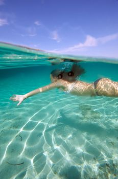 Underwater view of a woman swimming in the ocean