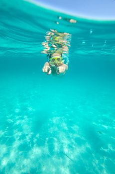 Underwater view of a woman swimming in the ocean