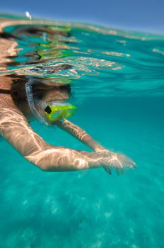 Underwater view of a woman swimming in the ocean