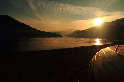 Como Lake, sunset with boat on the shore