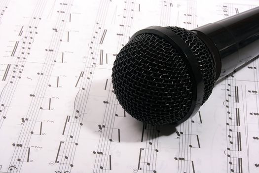 Black microphone and music (note) book.