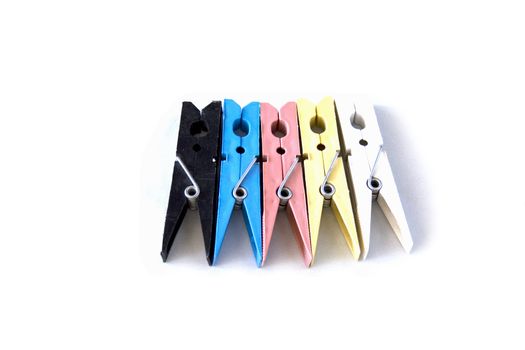 colored laundry pins on white background