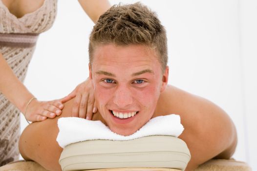 young man in a spa getting a massage