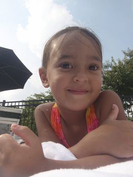 Little girl playing at neighborhood pool