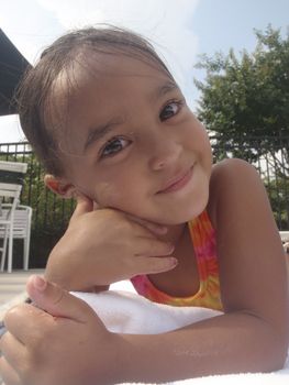 Little girl playing at neighborhood pool