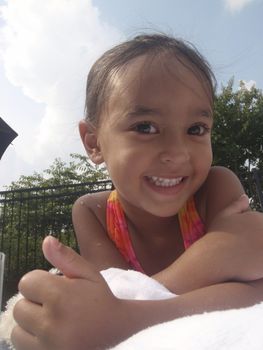 Little girl playing at neighborhood pool