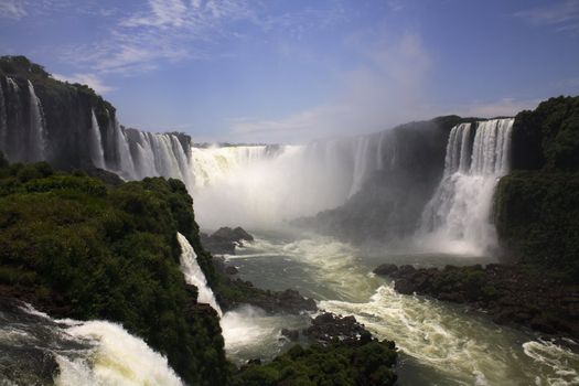 The Iguassu (or Iguazu) Falls is one of the largest masses of fresh water on the planet and divides, in South America, Brazil, Paraguay and Argentina. The waterfall system consists of 275 falls along 2.7 kilometres (1.67 miles) of the Iguazu River. Some of the individual falls are up to 82 metres (269 feet) in height, though the majority are about 64 metres (210 feet).