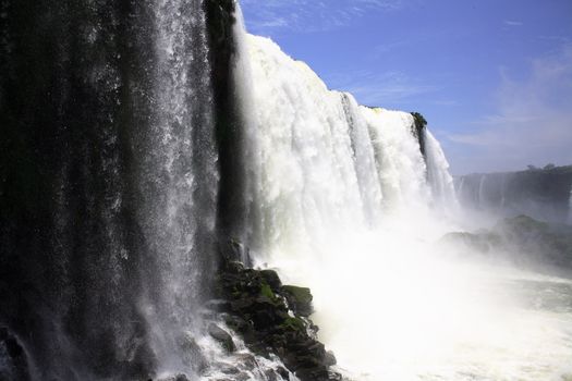 The Iguassu (or Iguazu) Falls is one of the largest masses of fresh water on the planet and divides, in South America, Brazil, Paraguay and Argentina. The waterfall system consists of 275 falls along 2.7 kilometres (1.67 miles) of the Iguazu River. Some of the individual falls are up to 82 metres (269 feet) in height, though the majority are about 64 metres (210 feet).