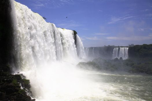 The Iguassu (or Iguazu) Falls is one of the largest masses of fresh water on the planet and divides, in South America, Brazil, Paraguay and Argentina. The waterfall system consists of 275 falls along 2.7 kilometres (1.67 miles) of the Iguazu River. Some of the individual falls are up to 82 metres (269 feet) in height, though the majority are about 64 metres (210 feet).