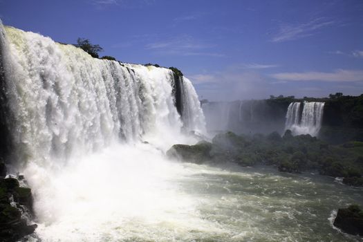 The Iguassu (or Iguazu) Falls is one of the largest masses of fresh water on the planet and divides, in South America, Brazil, Paraguay and Argentina. The waterfall system consists of 275 falls along 2.7 kilometres (1.67 miles) of the Iguazu River. Some of the individual falls are up to 82 metres (269 feet) in height, though the majority are about 64 metres (210 feet).