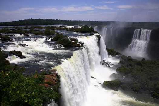 The Iguassu (or Iguazu) Falls is one of the largest masses of fresh water on the planet and divides, in South America, Brazil, Paraguay and Argentina. The waterfall system consists of 275 falls along 2.7 kilometres (1.67 miles) of the Iguazu River. Some of the individual falls are up to 82 metres (269 feet) in height, though the majority are about 64 metres (210 feet).