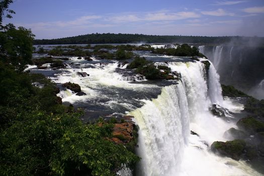 The Iguassu (or Iguazu) Falls is one of the largest masses of fresh water on the planet and divides, in South America, Brazil, Paraguay and Argentina. The waterfall system consists of 275 falls along 2.7 kilometres (1.67 miles) of the Iguazu River. Some of the individual falls are up to 82 metres (269 feet) in height, though the majority are about 64 metres (210 feet).