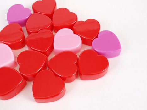 Assorted heart shapes in reds and purples arranged against a white background.