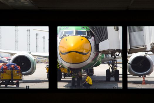 Nok Air. One of Thailand's budget airlines is parked for service and maintenance at Bangkok's domestic airport.