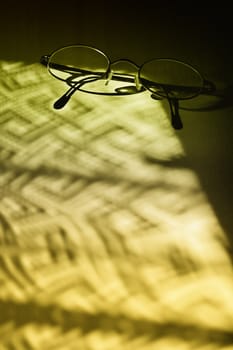 Eyglasses in dramatic shadows