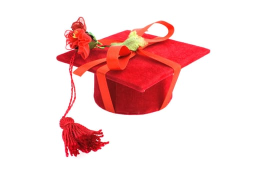 Red graduation cap isolated on white