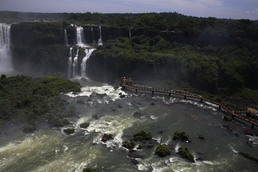 The Iguassu (or Iguazu) Falls is one of the largest masses of fresh water on the planet and divides, in South America, Brazil, Paraguay and Argentina. The waterfall system consists of 275 falls along 2.7 kilometres (1.67 miles) of the Iguazu River. Some of the individual falls are up to 82 metres (269 feet) in height, though the majority are about 64 metres (210 feet).