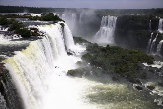 The Iguassu (or Iguazu) Falls is one of the largest masses of fresh water on the planet and divides, in South America, Brazil, Paraguay and Argentina. The waterfall system consists of 275 falls along 2.7 kilometres (1.67 miles) of the Iguazu River. Some of the individual falls are up to 82 metres (269 feet) in height, though the majority are about 64 metres (210 feet).