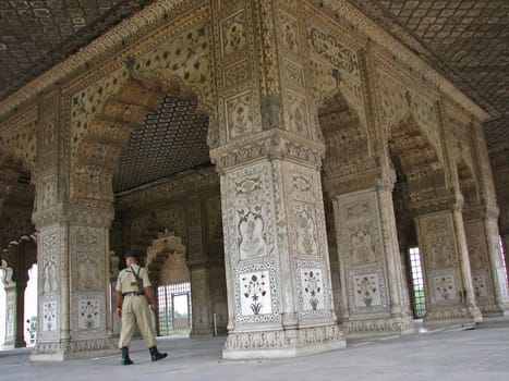 A guard walks through a palace in Red Fort in New Delhi, India.