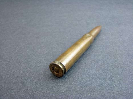 An old bullet angled against a dark background.